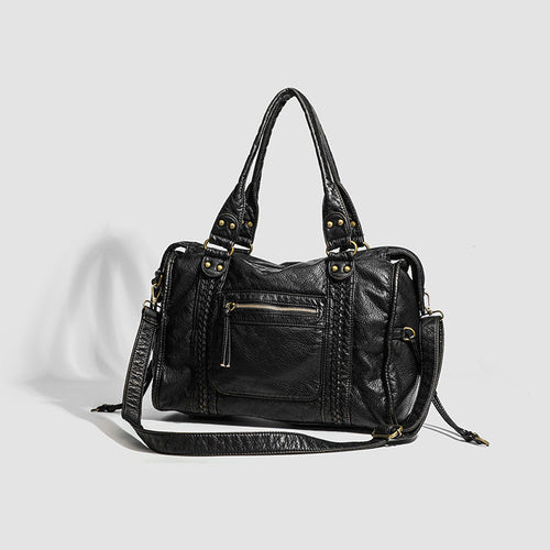 Black leather handbag on a light gray background