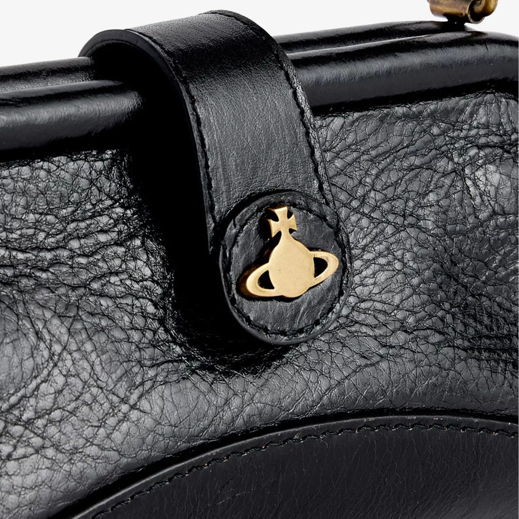 Close-up of a black leather handbag with a gold logo on a white background